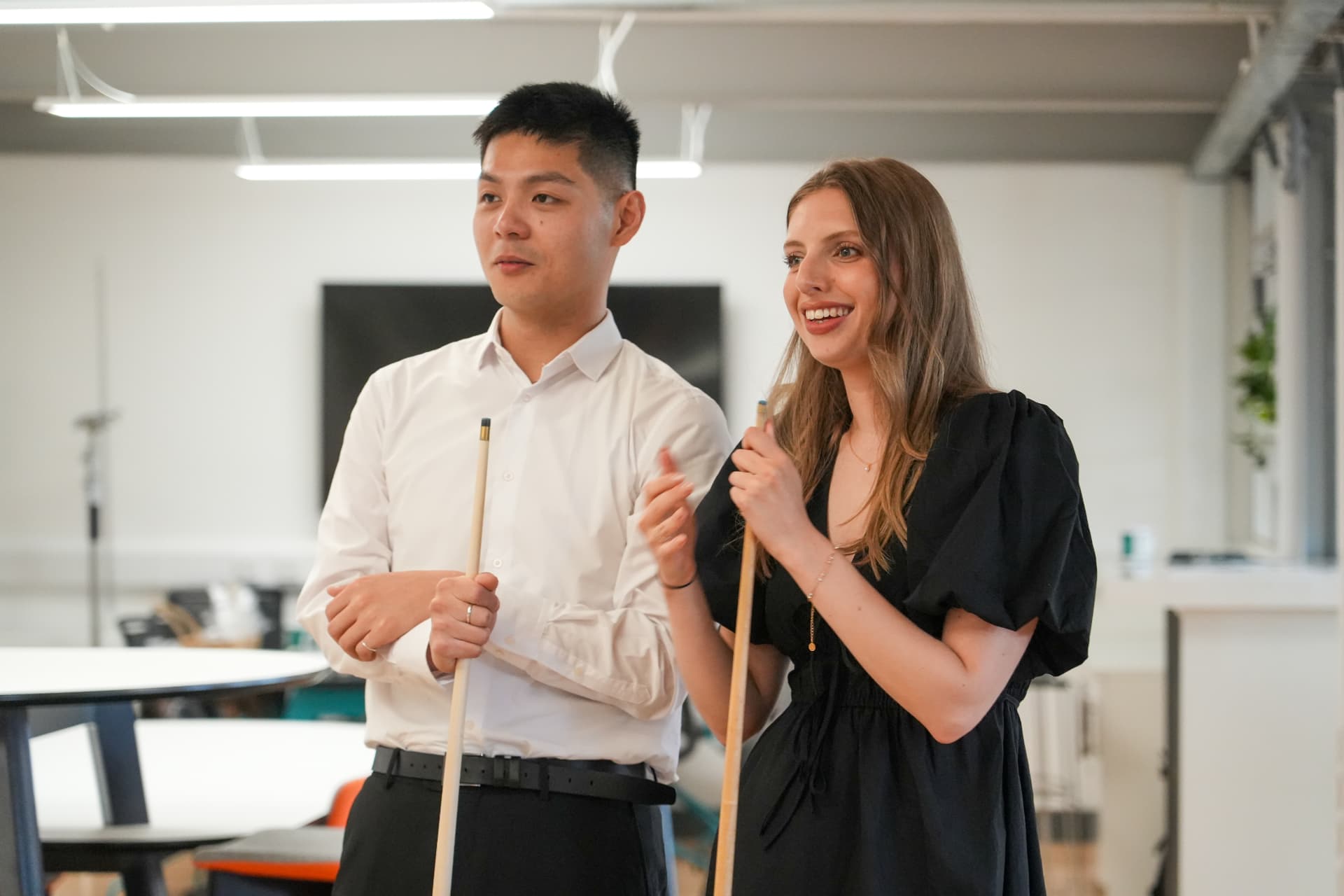 Two CPW colleagues chatting over a game of pool in the office